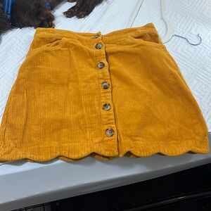 Burnt yellow mini skirt with scalloped bottom